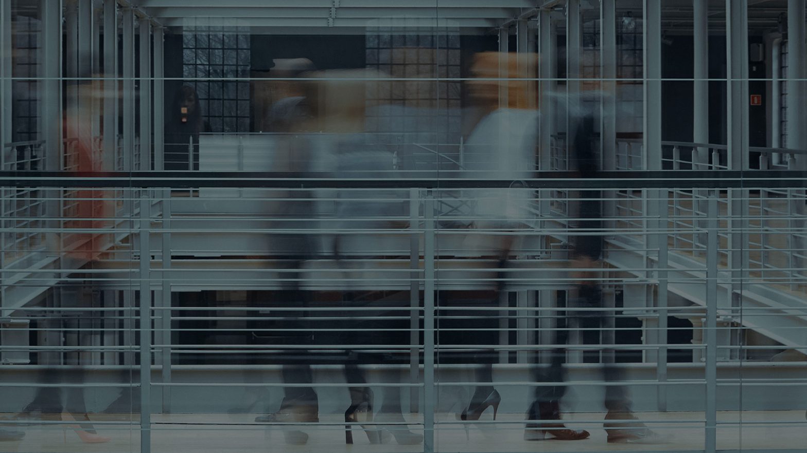 Blured picture of people waking across a walkway