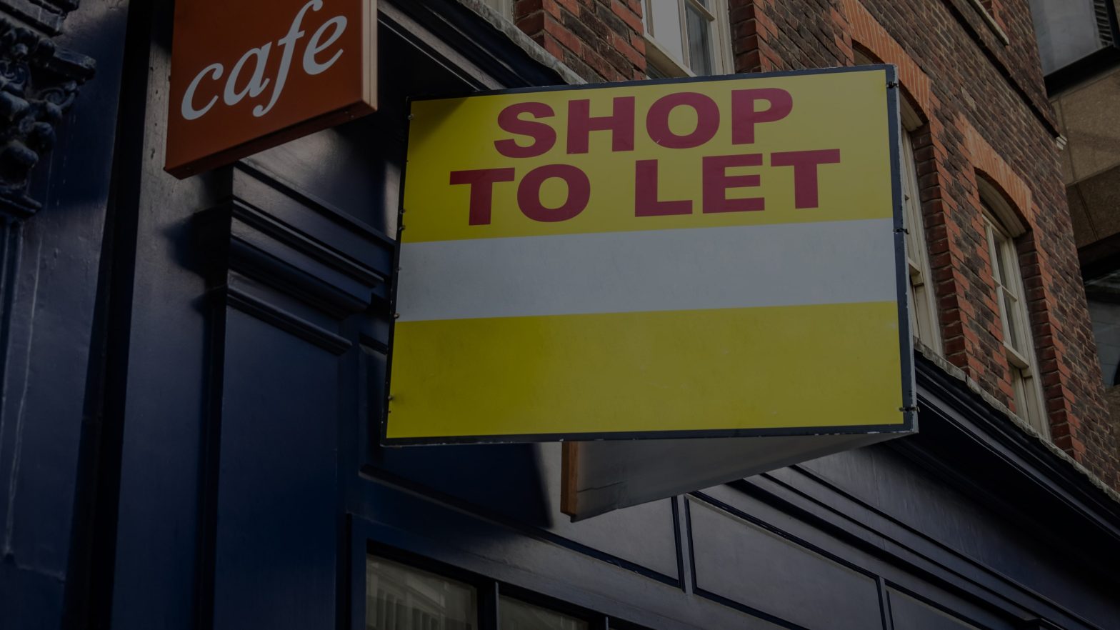 Shop to let sign outside of a cafe