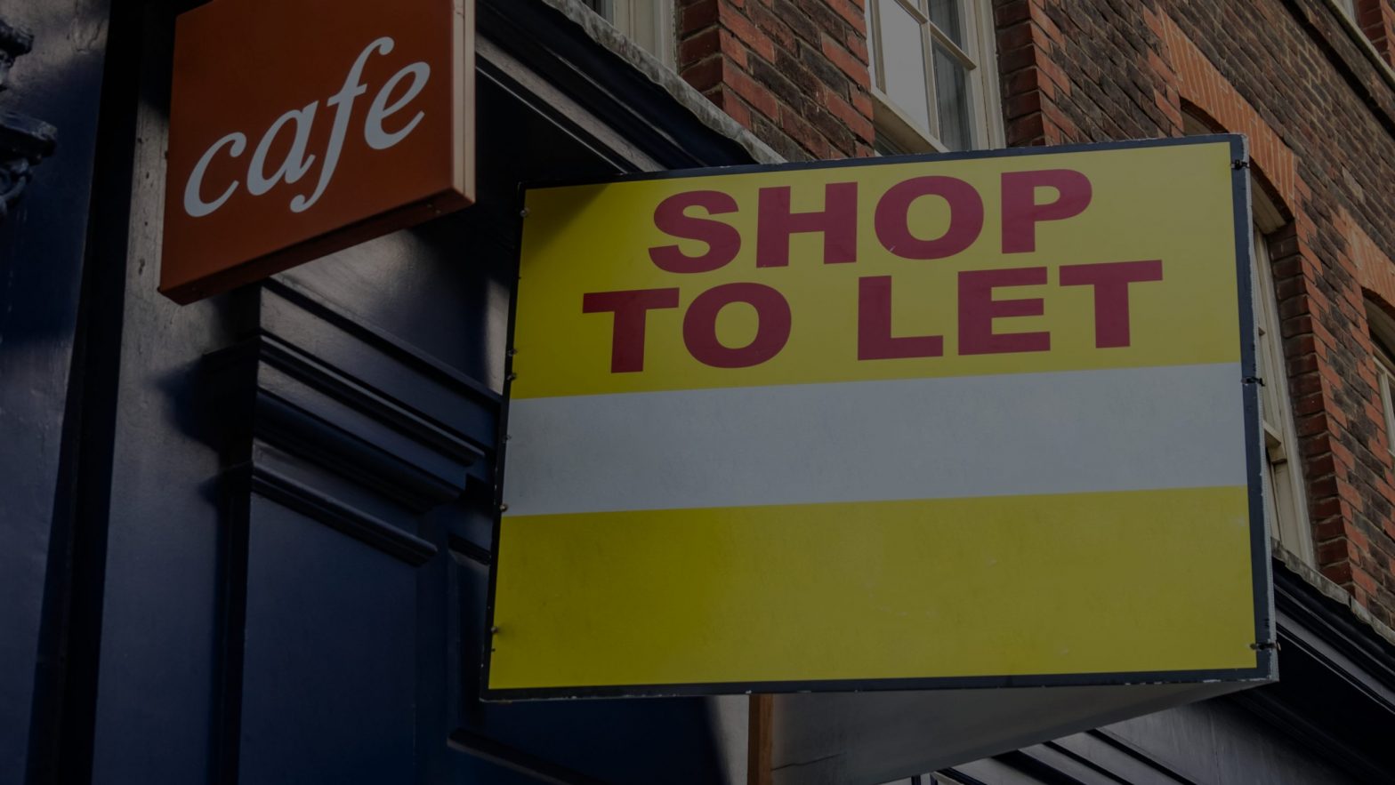 Shop to let sign outside of a cafe
