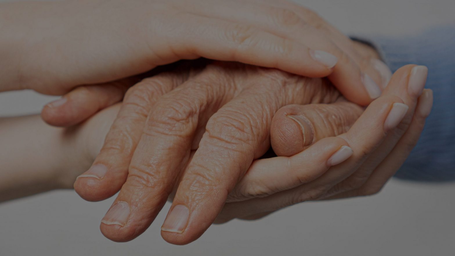 Woman holding elderly mans hand