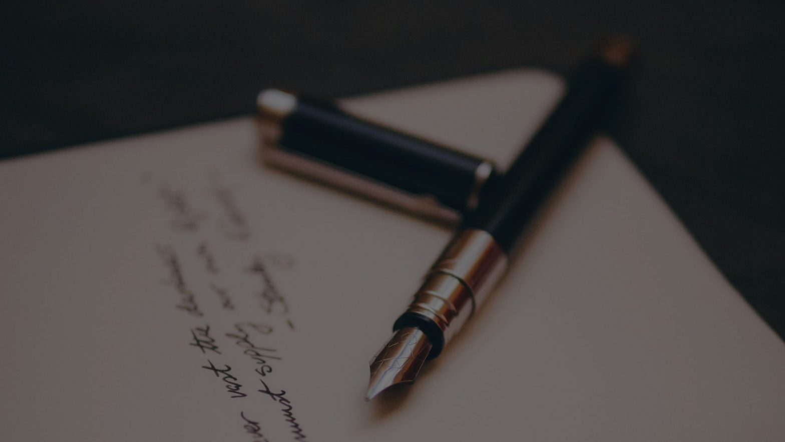 Fountain pen sitting on paper